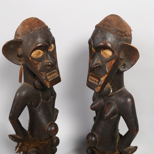 151 - A pair of Congo Tribal carved wood standing figures, height 67cm