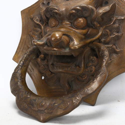 154 - A Chinese brass dragon design door knocker, height 26cm