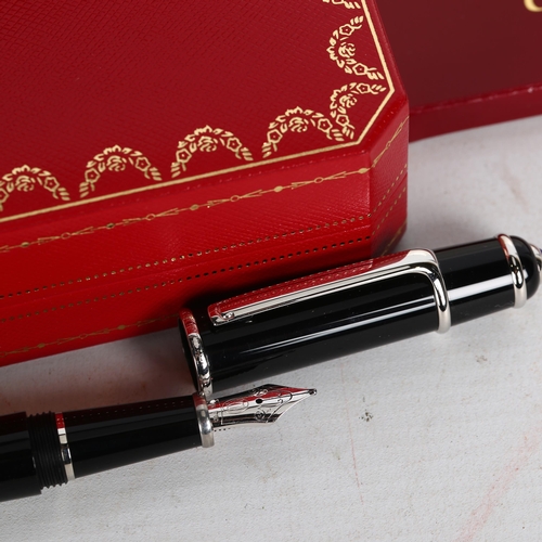 195 - A Cartier black/steel-cased fountain pen, spare ink filler, original case and box, perfect condition