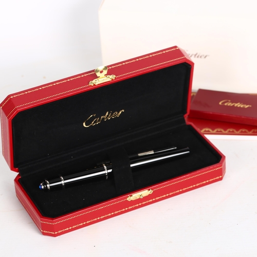 195 - A Cartier black/steel-cased fountain pen, spare ink filler, original case and box, perfect condition