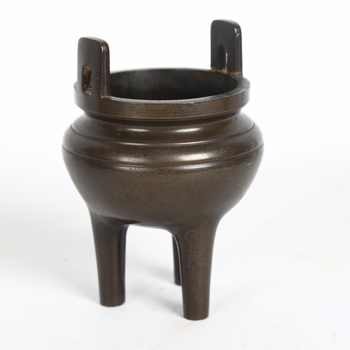 198 - A Chinese patinated bronze incense burner on 3 feet, height to rim 11cm