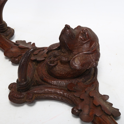 41 - 19th century Black Forest carved wood wall-hanging coat rack, with dog's head mount, width 40cm