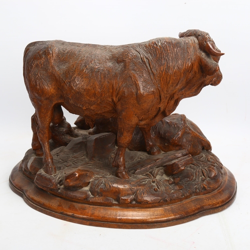 42 - A superb 19th century Black Forest carved wood sculpture of a bull cow and calf, on naturalistic bas... 