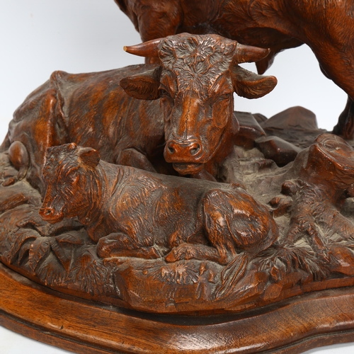 42 - A superb 19th century Black Forest carved wood sculpture of a bull cow and calf, on naturalistic bas... 