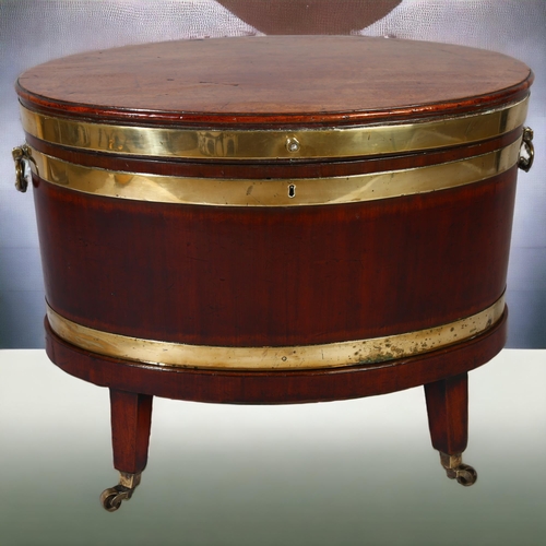 229 - A George IV mahogany oval wine cooler with brass banding and fittings on stand, height 57cm, width 7... 