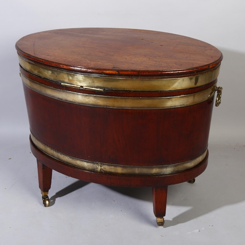 229 - A George IV mahogany oval wine cooler with brass banding and fittings on stand, height 57cm, width 7... 