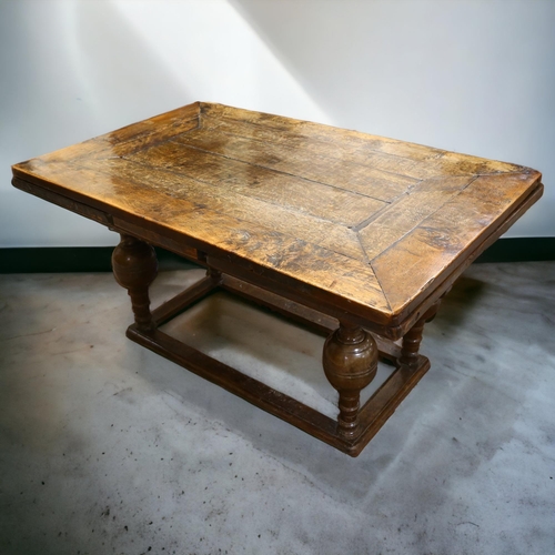 233 - An 18th century oak, extending, refectory table with two drawer leaves on baluster legs on box frame... 