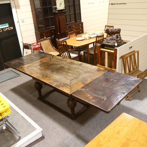 233 - An 18th century oak, extending, refectory table with two drawer leaves on baluster legs on box frame... 