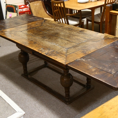 233 - An 18th century oak, extending, refectory table with two drawer leaves on baluster legs on box frame... 