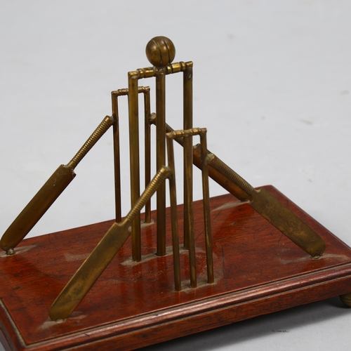 37 - A late 19th century cricket themed letter stand, brass stumps and bats on mahogany base with brass c... 