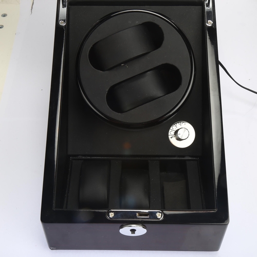 1036 - A modern automatic double watch winder, with 3 sub-compartments and mains/battery power, height 21cm... 