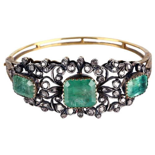 1106 - A fine Victorian emerald and diamond hinged bangle, unmarked gold and silver-topped openwork setting... 