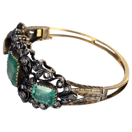 1106 - A fine Victorian emerald and diamond hinged bangle, unmarked gold and silver-topped openwork setting... 