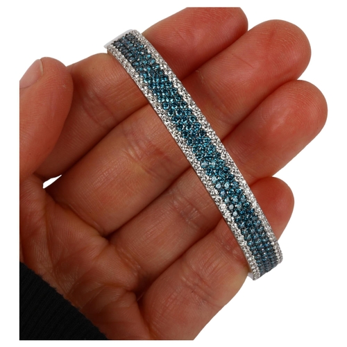 1109 - EFFY - an American 14ct white gold Bella Bleu blue diamond and diamond hinged bangle, pave set with ... 