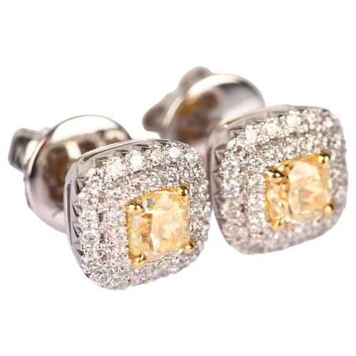 1111 - A pair of fancy yellow diamond and diamond halo cluster earrings, 18ct white gold stud fittings with... 