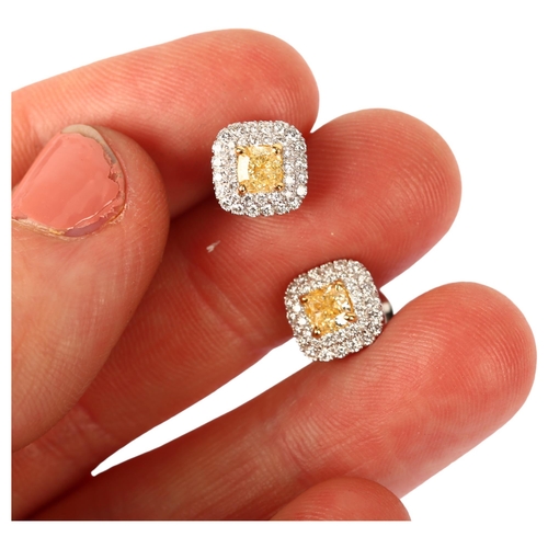 1111 - A pair of fancy yellow diamond and diamond halo cluster earrings, 18ct white gold stud fittings with... 