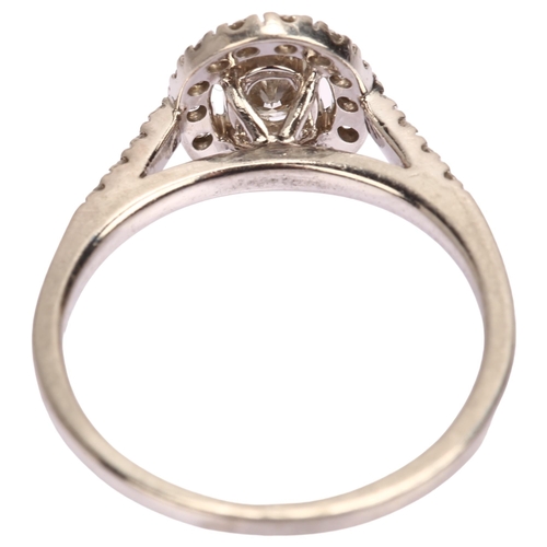 1118 - A modern platinum diamond oval halo cluster ring, London 2014, set with oval and modern round brilli... 