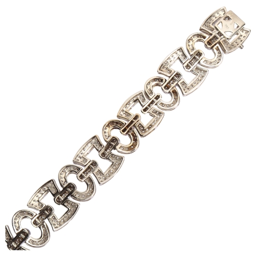 1120 - A modern 18ct white gold diamond panel bracelet, geometric design with square and oval panels, set w... 