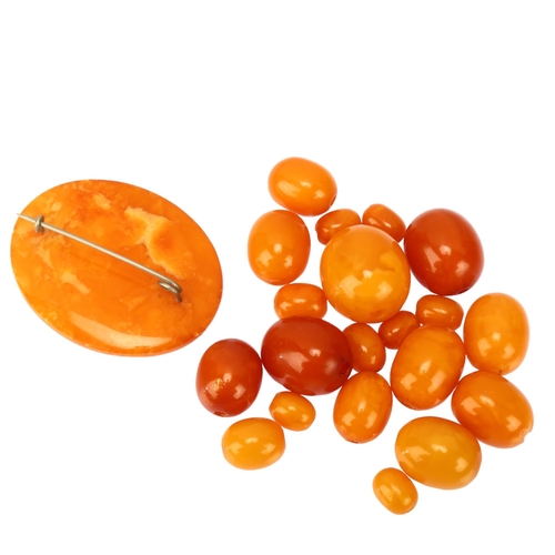 1128 - A group of loose graduated butterscotch amber beads, bead lengths 21.1 - 9.5mm, and an oval amber br... 