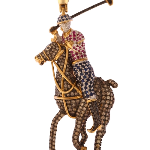 1150 - A large modern 9ct gold sapphire ruby and diamond 3-dimensional polo player pendant, pave set with r... 