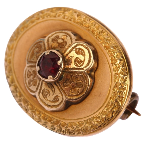 1170 - A Victorian garnet memorial brooch, unmarked yellow metal closed-back settings, of oval form with ce... 