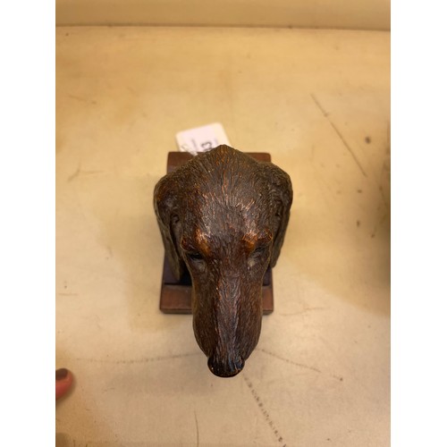 43 - A Black Forest carved and stained wood sculpture of a hound's head, with glass eyes, on block base, ... 