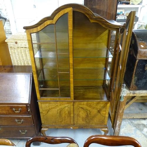 2571 - A continental walnut veneered arch topped display cabinet with 2 glazed doors and cupboard under, ra... 