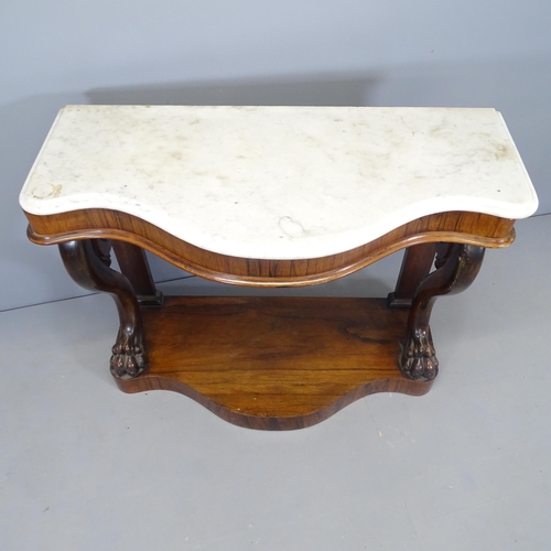 2597 - A 19th century French rosewood and marble topped console table of serpentine form, with scrolled leg... 