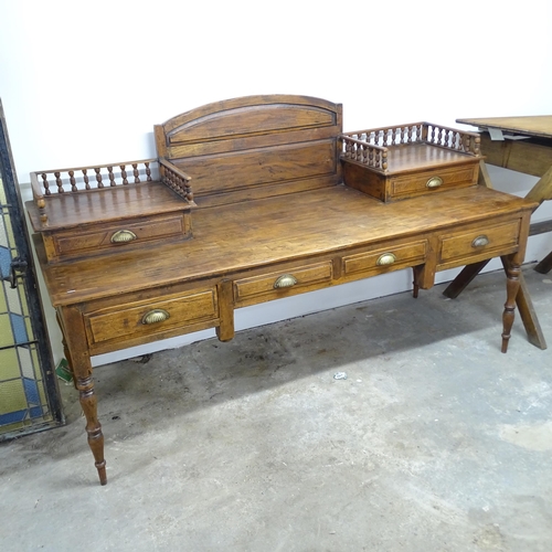 2606 - An large Indonesian hardwood desk, with raised back, gallery and six drawers. Overall 200x118x65cm.