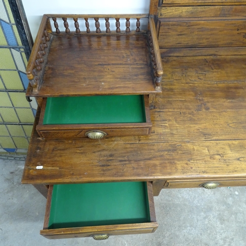 2606 - An large Indonesian hardwood desk, with raised back, gallery and six drawers. Overall 200x118x65cm.