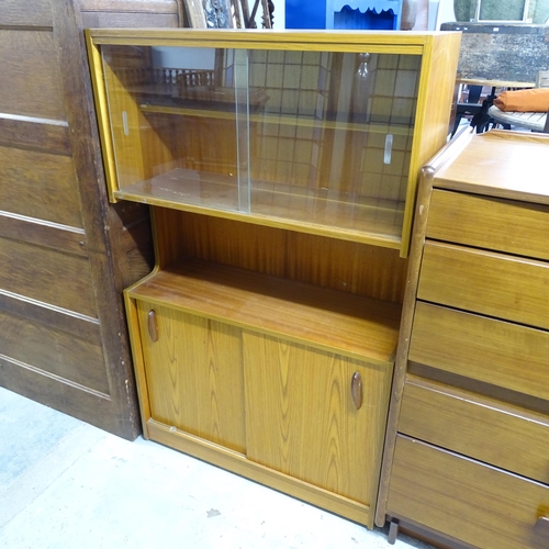 2619 - A mid-century teak display / drinks cabinet, with two glass sliding doors and cupboards under. 77x12... 