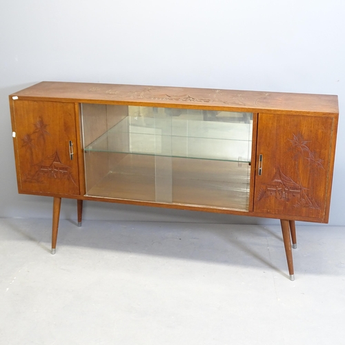 2624 - A Japanese elm sideboard, with two glass sliding doors between two cupboards, carved decoration and ... 