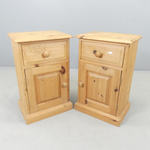 2595 - A pair of modern pine bedside pot cupboards. 39x62x28cm.