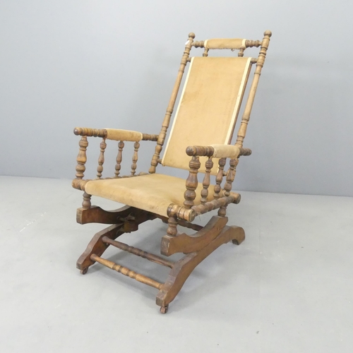 2605 - An American stained beech and upholstered rocking chair.