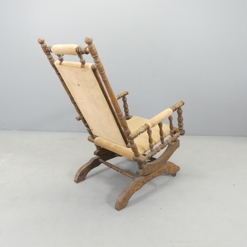 2605 - An American stained beech and upholstered rocking chair.