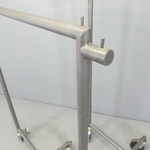 2629 - Two similar tubular metal shop display clothes rails on wheeled base. Tallest 101x147x54cm.