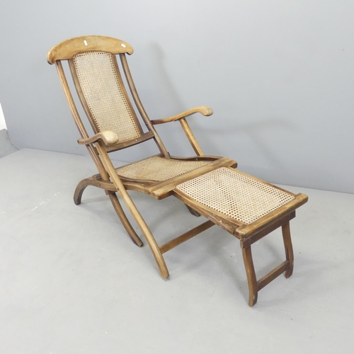 2630 - A vintage teak and cane panelled folding steamer lounge chair.