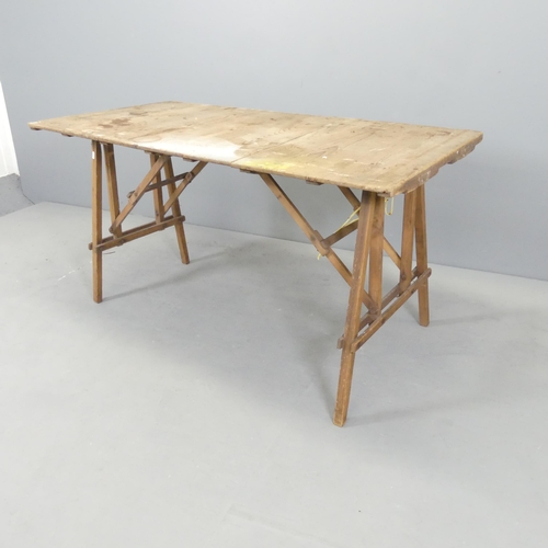 2636 - A vintage pine folding trestle table. 131x68x68cm.