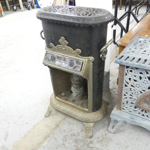 2649 - An antique cast iron station heater, fitted with paraffin lamp, with leadlight panel. 42x68x34cm.