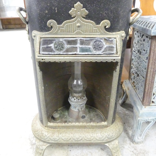 2649 - An antique cast iron station heater, fitted with paraffin lamp, with leadlight panel. 42x68x34cm.