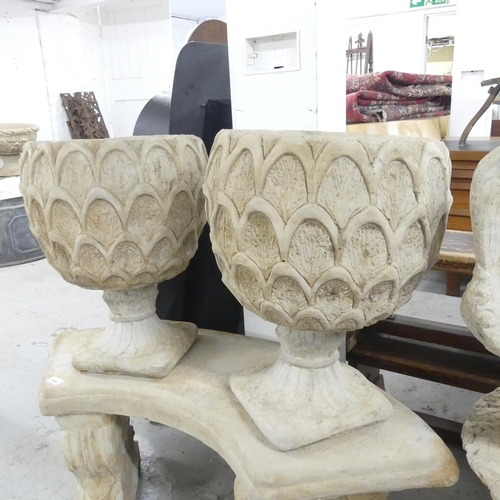 2657 - A pair of modern concrete two-section garden urns, with pineapple decoration. 42x53cm.