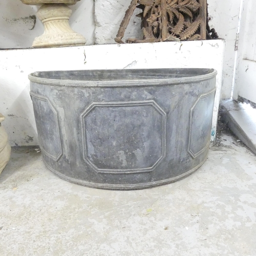 2672 - A semi-circular lead garden planter. 82x40x37cm.