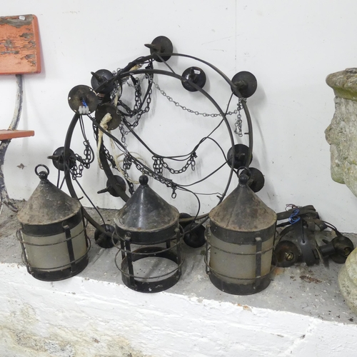 2673 - A pair of cast iron circular electric candelabra, diameter 63cm, and three hanging lanterns, 33x40cm... 