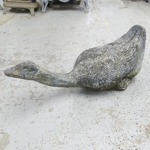 2674 - A composition garden statue, study of a goose. Length 69cm.