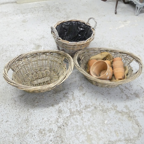 2678 - Three wicker baskets, tallest 46x35cm, and 16 terracotta pots.