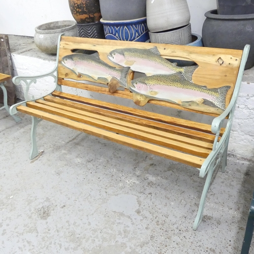 2683 - A teak slatted garden bench with cast iron ends, painted with fish decoration by Clive Fredriksson. ... 