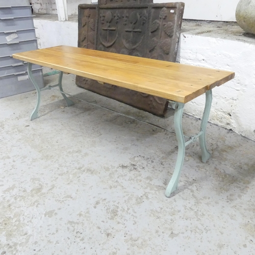 2684 - A teak plank top garden bench / low table on painted cast iron base. 120x43x36cm.