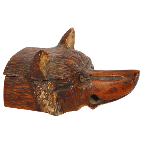 104 - An unusual early 20th century carved fox head design inkwell with glass eyes, L12cm