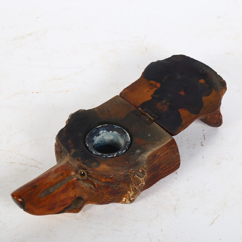 104 - An unusual early 20th century carved fox head design inkwell with glass eyes, L12cm