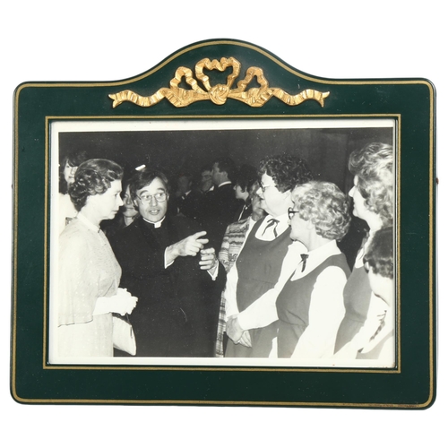 111 - A framed photograph of Her Majesty Queen Elizabeth II during an official visit